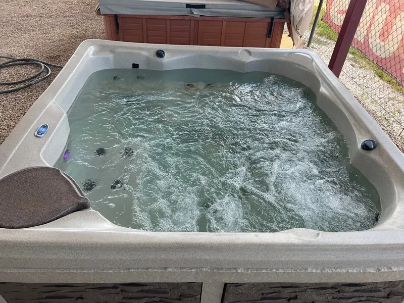 A tan-shell hot tub running on the Longhorn lot in Georgetown